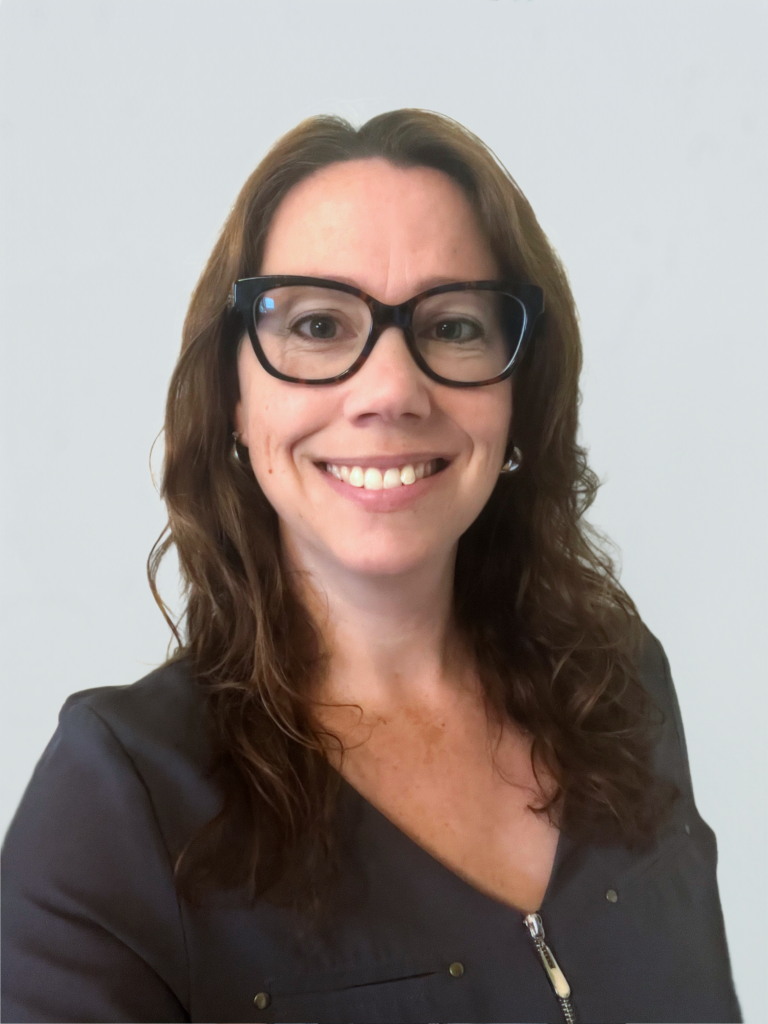 Karen McKeogh, a white woman with long brown hair and glasses